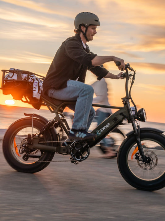 EWHIP electric bike rider cruising along the Australian coast at sunset