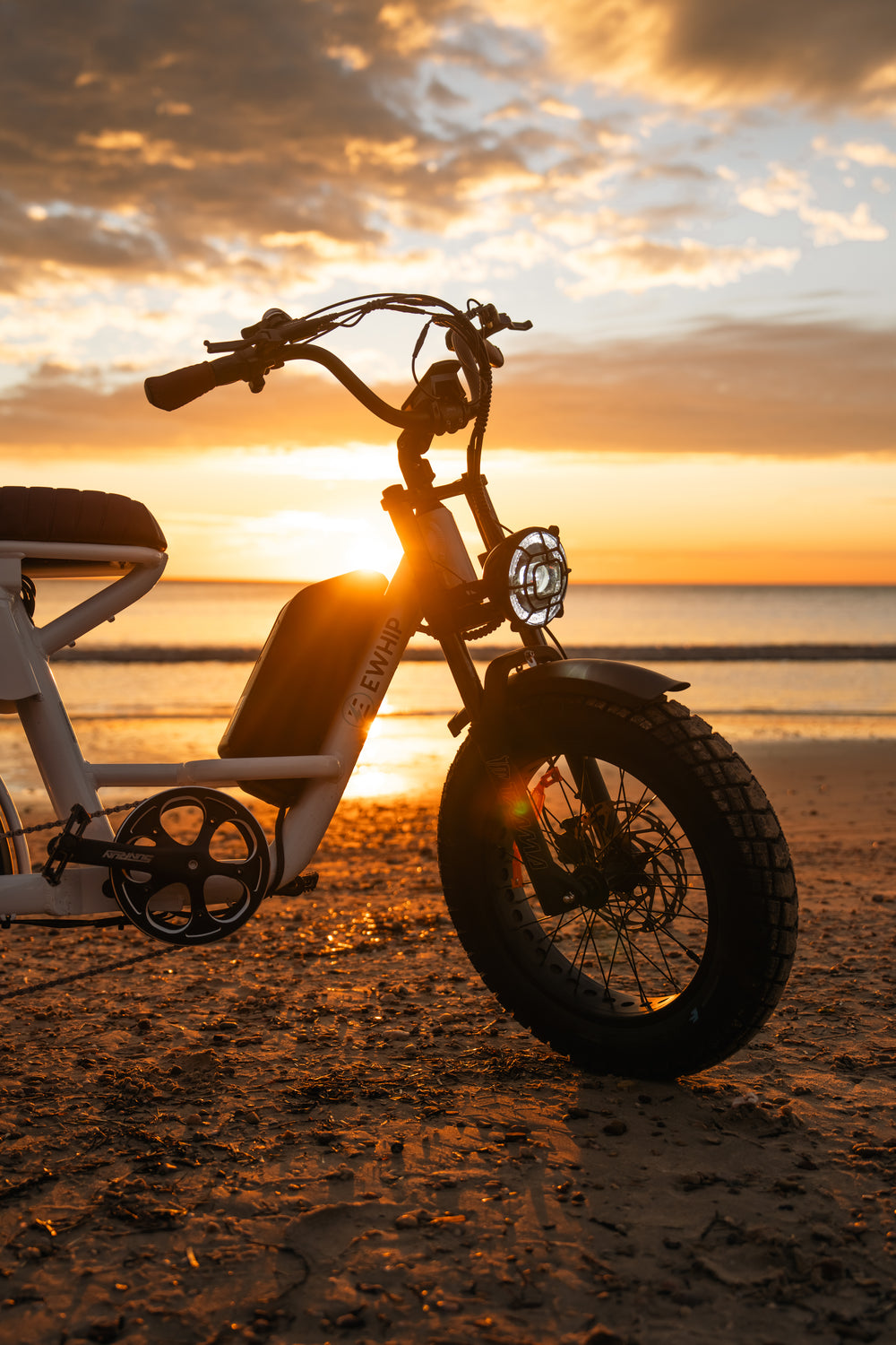 The Captain electric fat tyre bike white step-through frame and battery at sunset — street legal Australia