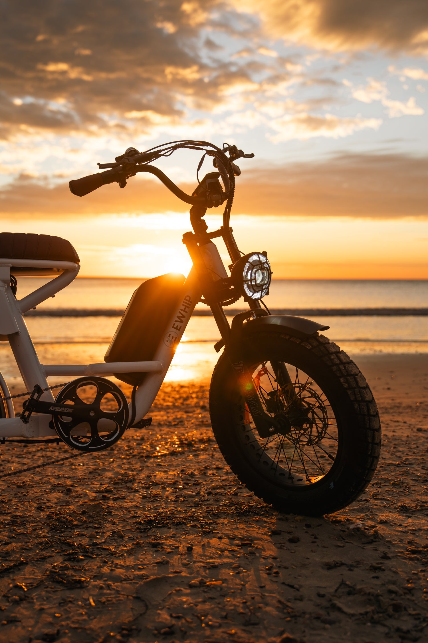 The Captain electric fat tyre bike white step-through frame and battery at sunset — street legal Australia