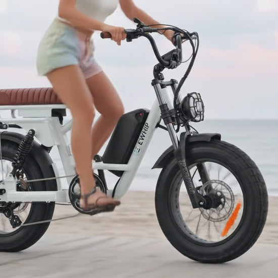 Slow motion video thumbnail of girl cruising on The Captain street legal ebike along a beach promenade