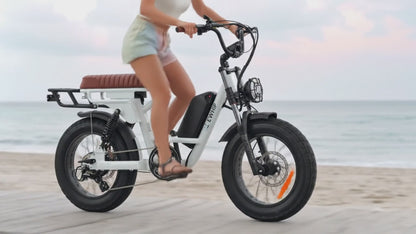 Slow motion video thumbnail of girl cruising on The Captain street legal ebike along a beach promenade